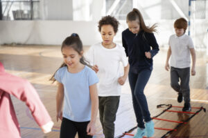 Group of children participating in agility ladder drills Click to go to our Group Fitness Classes page